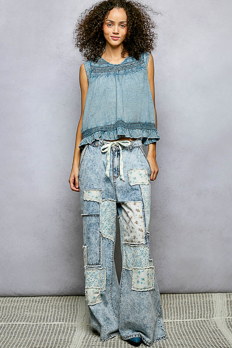Denim blue sleeveless cotton blouse with ruffled details, button closure on back, and trim accents by Trendsi.