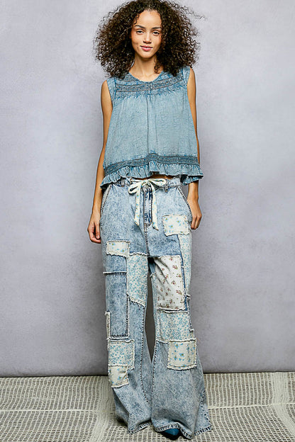 Denim blue sleeveless cotton blouse with ruffled details, button closure on back, and trim accents by Trendsi.