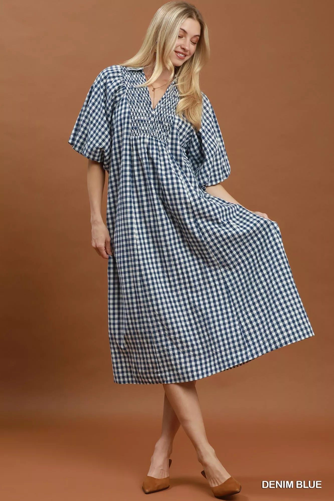 Blue plaid midi dress with puff sleeves from Umgee, featuring a relaxed fit and stylish design for casual or semi-formal occasions.