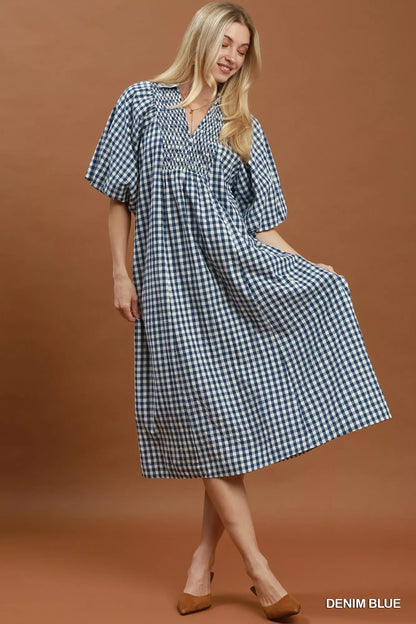 Blue plaid midi dress with puff sleeves from Umgee, featuring a relaxed fit and stylish design for casual or semi-formal occasions.
