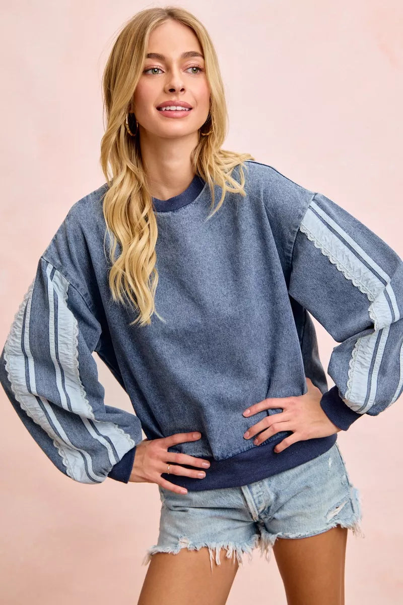 BiBi washed denim sweatshirt by Trendsi featuring lace contrast sides and casual, relaxed fit for stylish everyday wear.