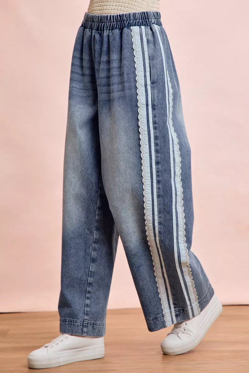 Trendsi BiBi Washed Lace Contrast Sided Jeans featuring distressed denim and lace side panels on a model.