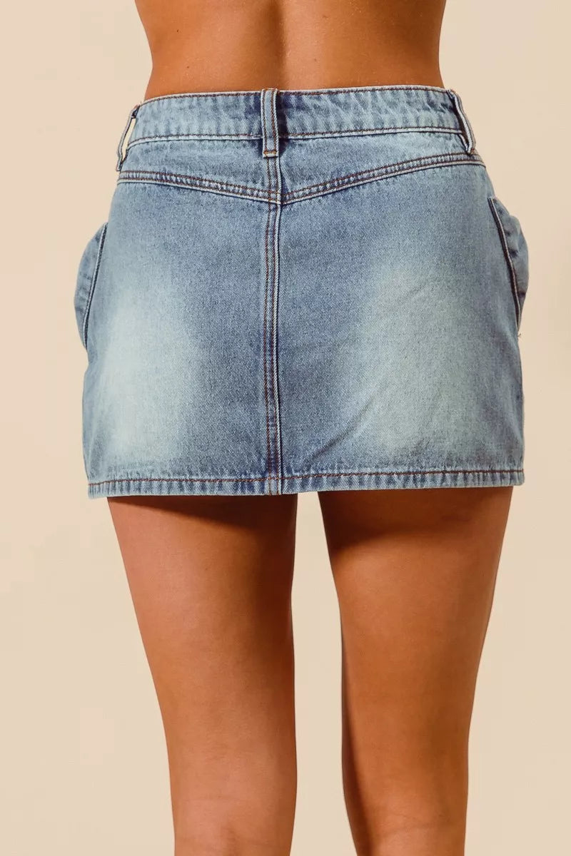 Trendsi SO ME Bow Knot Pocket Denim Mini Skirt featuring a front bow detail and classic denim fabric.