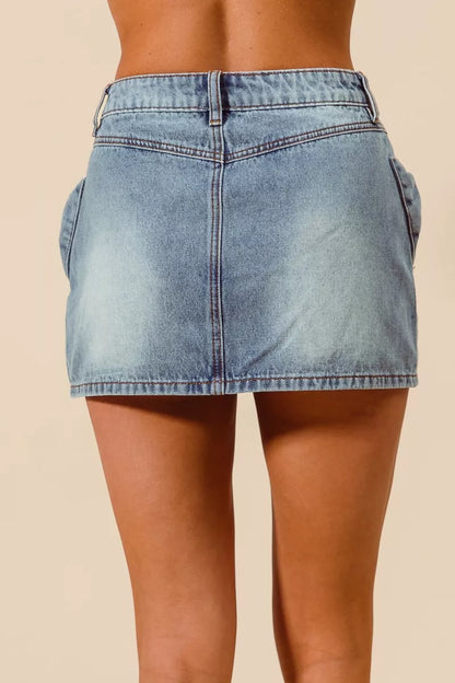 Trendsi SO ME Bow Knot Pocket Denim Mini Skirt featuring a front bow detail and classic denim fabric.
