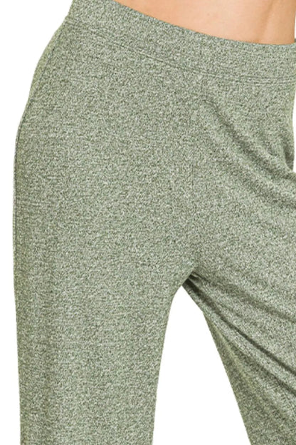 Olive green Zenana flare pants with soft elastic waist and wide-leg fit, styled for casual or trendy outfits.