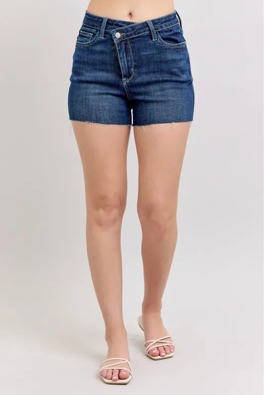 Plus size Judy Blue high waist denim shorts with criss-cross waistband and full size fit, featuring classic blue denim fabric.