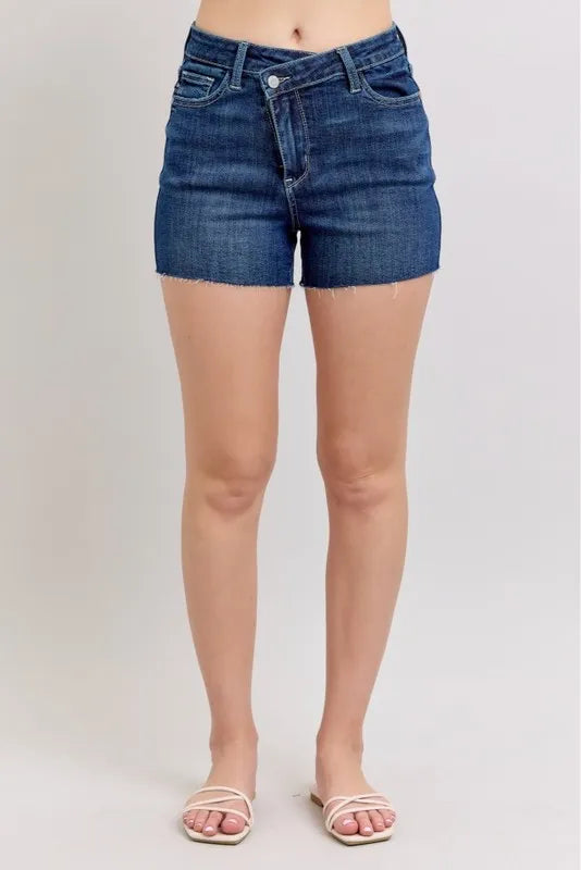 Plus size Judy Blue high waist denim shorts with criss-cross waistband and distressed details, showcasing a stylish fit and design.