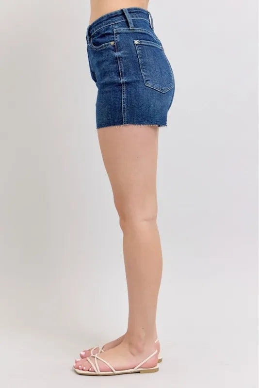 Plus size Judy Blue high waist denim shorts with criss-cross waistband, full-length front view showing distressed details.