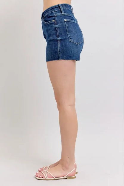 Plus size Judy Blue high waist denim shorts with criss-cross waistband, full-length front view showing distressed details.
