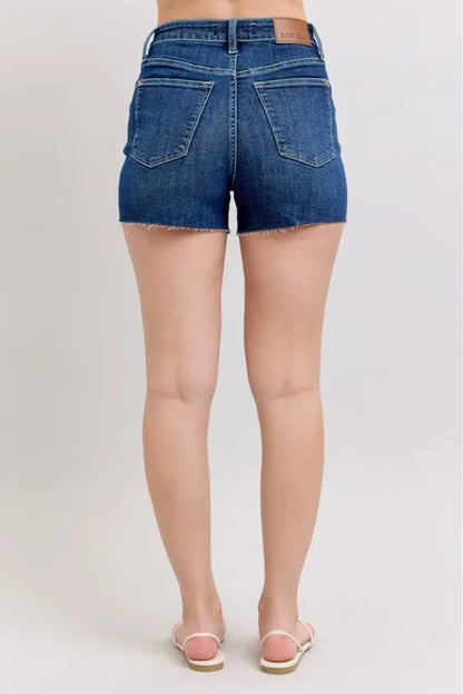Plus size Judy Blue high waist denim shorts with criss-cross waistband, showcasing the stylish fit and design.