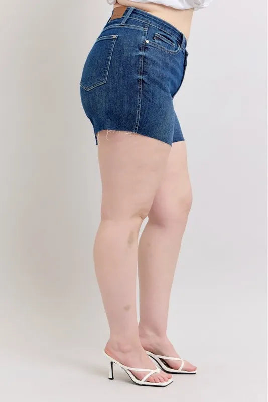 Full view of Judy Blue plus size high waist denim shorts with criss-cross waistband and distressed details, showing fit and style.