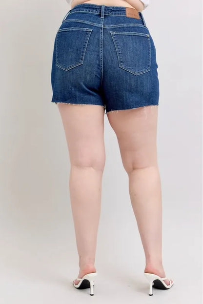 Plus size Judy Blue high waist denim shorts with criss-cross waistband and distressed details, full length view.