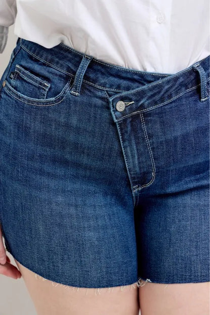Plus size Judy Blue high waist denim shorts with criss-cross waistband and full size fit, featuring classic blue denim.