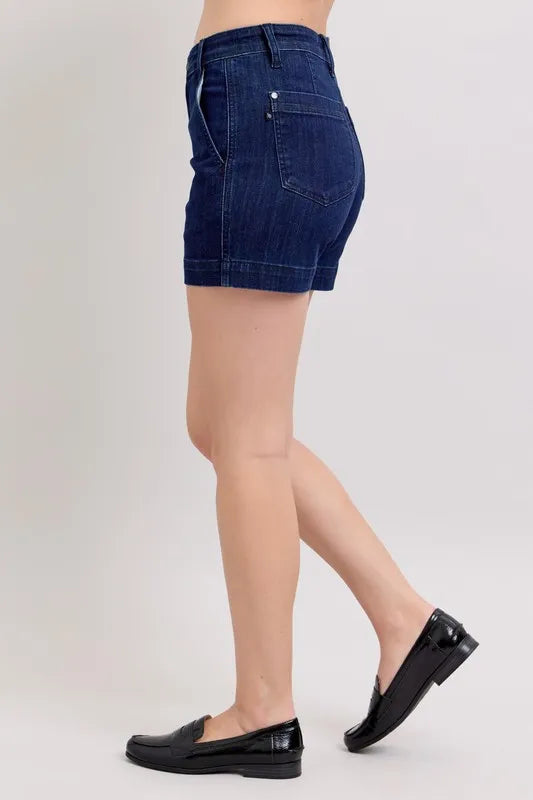Plus size Judy Blue high waist denim shorts with a classic blue wash, featuring a relaxed fit and stylish rolled hems.