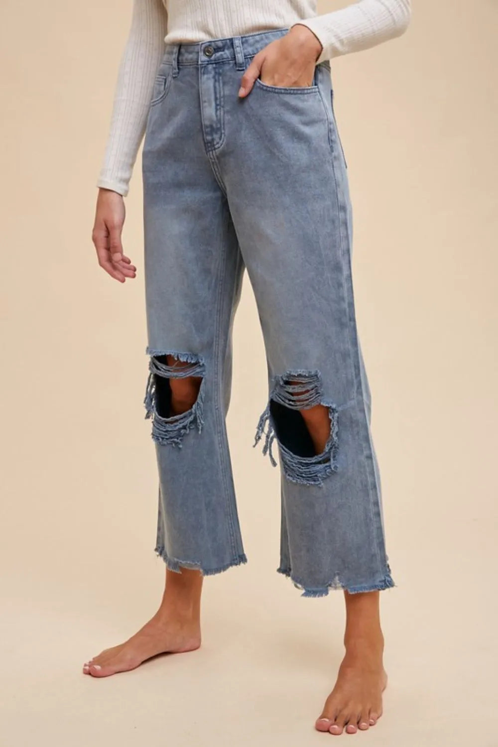 Dusty blue Annie Wear distressed raw hem jeans by Trendsi, featuring a relaxed fit and frayed hem with a casual, stylish look.