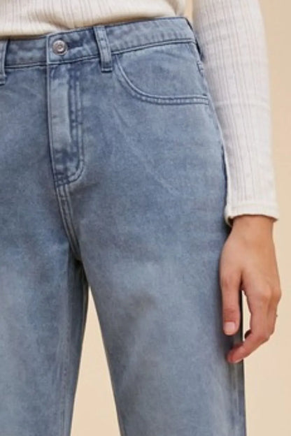 Dusty blue Annie Wear distressed raw hem jeans by Trendsi, featuring a relaxed fit and frayed hem detail.