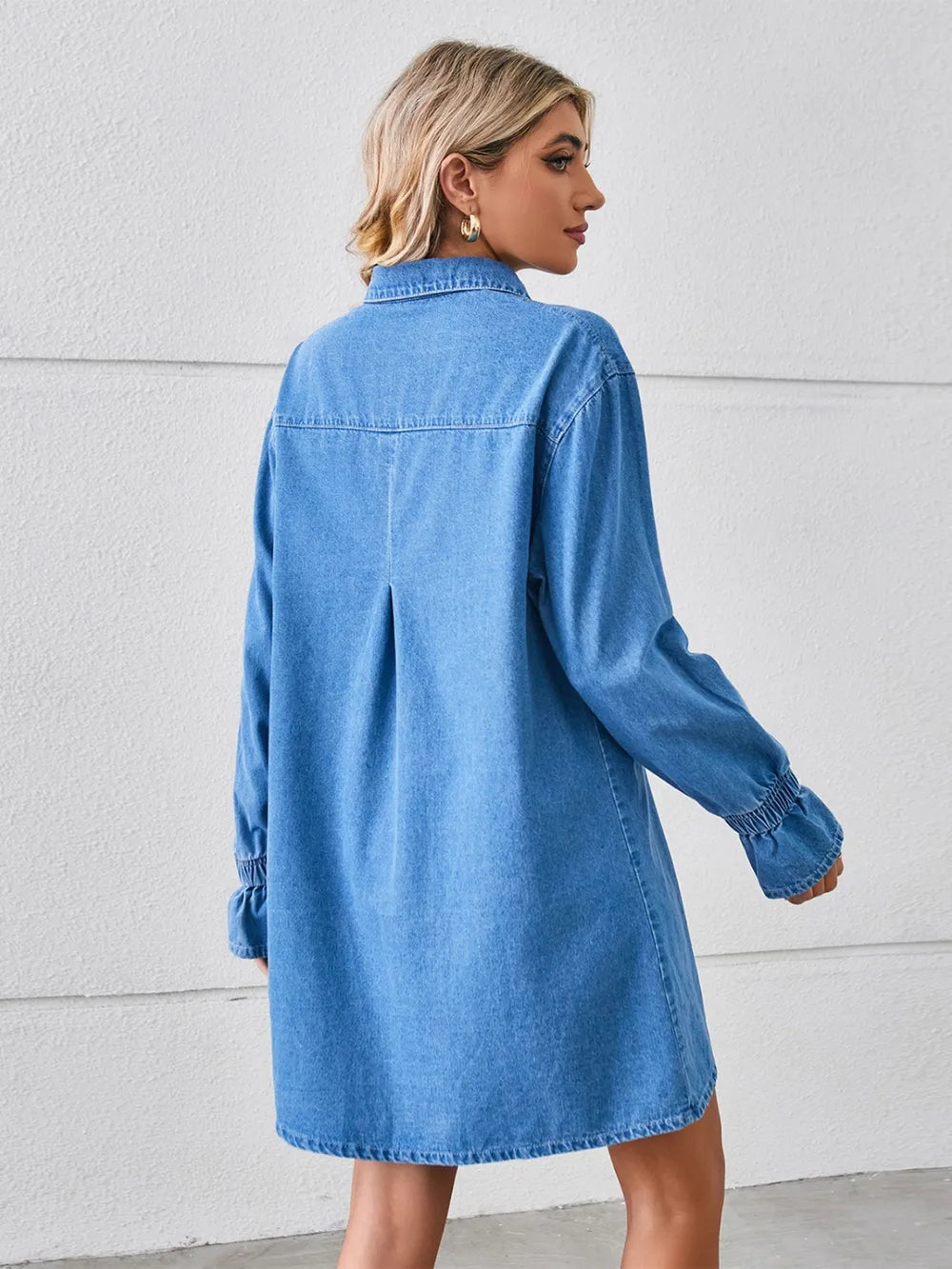 Dusty blue pocketed dropped shoulder mini denim dress by Trendsi, featuring front pockets and relaxed fit.