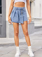 Dusty blue raw hem denim skort by Trendsi featuring a casual, stylish design with front pockets and distressed detailing.