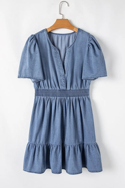 Dusty blue denim mini dress with ruffled hem, smocked waist, and flutter sleeves by Trendsi, perfect for casual summer wear.