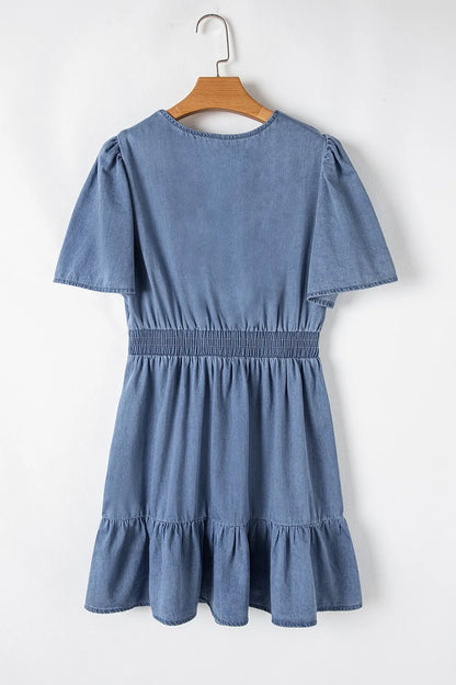 Dusty blue denim mini dress with ruffled hem, smocked bodice, and flutter sleeves from Trendsi.
