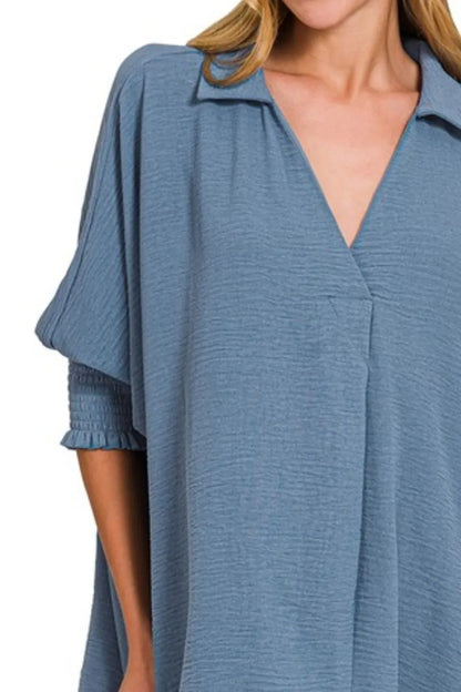 Dusty blue Zenana Airflow Collar Tee with smocked sleeve band, shown on a model, featuring a relaxed fit and stylish design.
