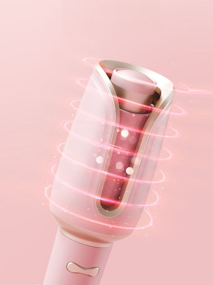 Dusty pink automatic rotating ceramic hair curling iron with North American plug by Trendsi, showing the device with a curling barrel.