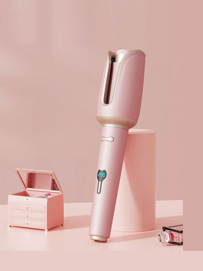 Dusty pink automatic rotating ceramic hair curling iron by Trendsi, North American plug, with rotating barrel for easy styling.
