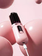 Dusty pink portable heated hair straightening comb from Trendsi, compact design for easy styling and straightening on the go.