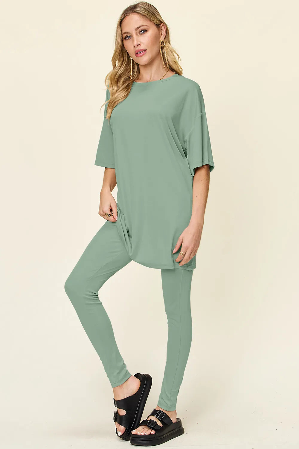 Dusty pink Trendsi double take full-size round neck dropped shoulder T-shirt and matching leggings set, casual and comfortable.
