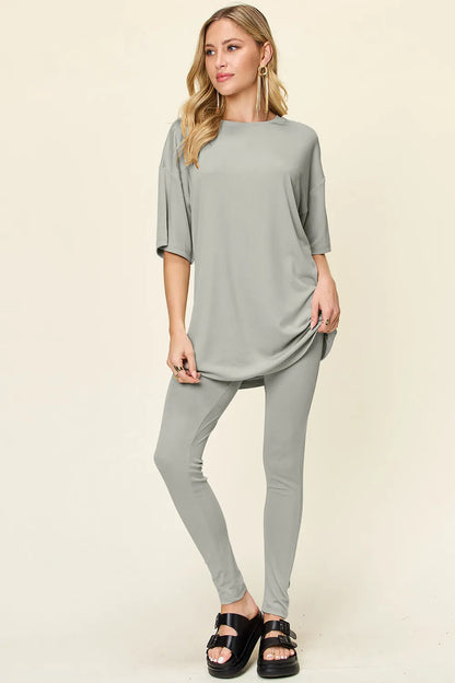 Dusty pink Trendsi double take full size round neck dropped shoulder t-shirt and matching leggings set on model.