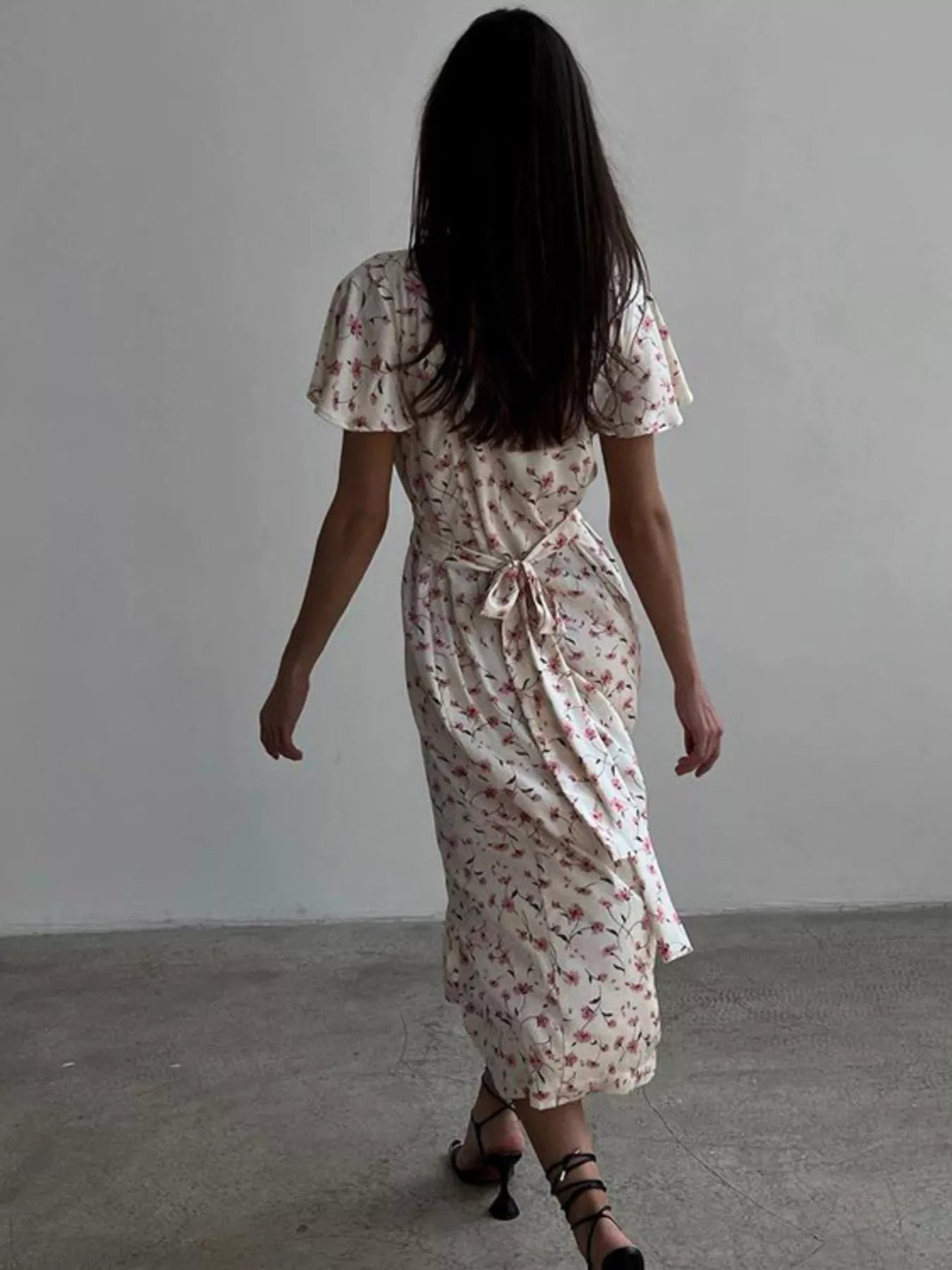 Dusty pink floral print midi dress with V-neck and flutter sleeves by Trendsi, featuring a feminine and flowing design.