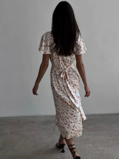 Dusty pink floral print midi dress with V-neck and flutter sleeves by Trendsi, featuring a feminine and flowing design.