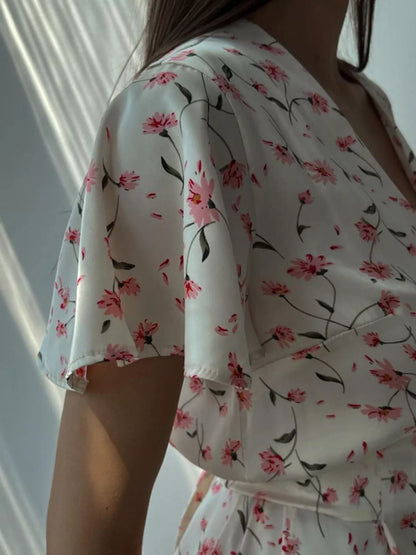 Dusty pink floral print V-neck midi dress with flutter sleeves from Trendsi, showcasing a stylish and feminine design.