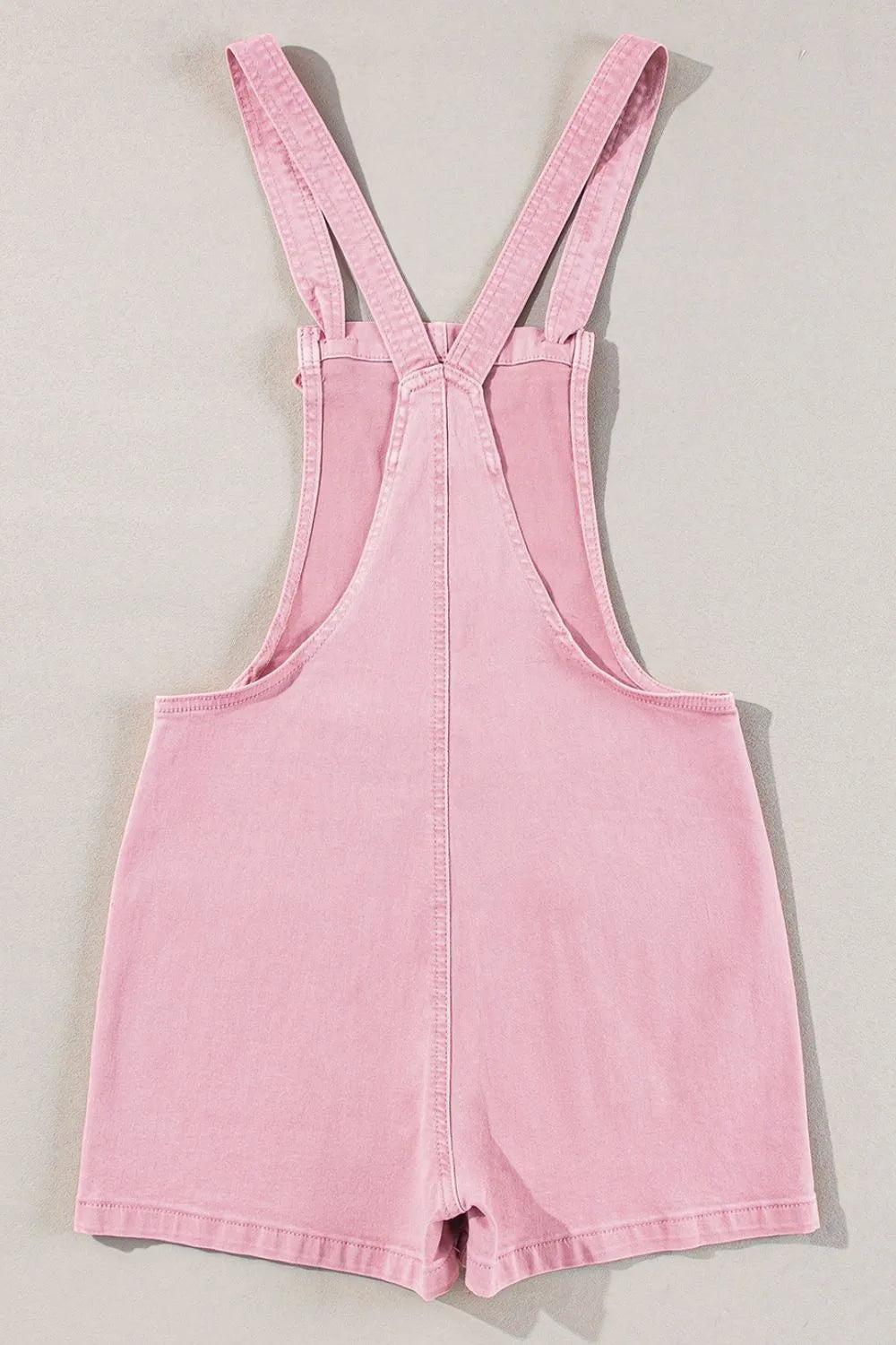 Dusty pink Knot Straps denim overalls with front pockets and adjustable straps, casual and stylish for everyday wear.