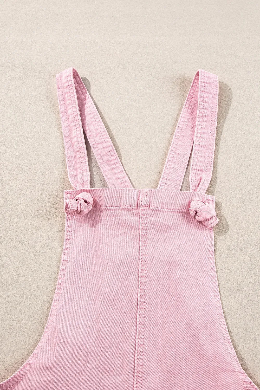 Dusty pink denim overalls with knot straps and front pockets, trendy Trendsi women's casual jumpsuit or overall outfit.