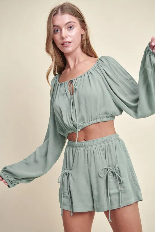 Dusty sage MABLE Gauze long sleeve button crop top and matching short set by Trendsi, lightweight and breathable fabric.