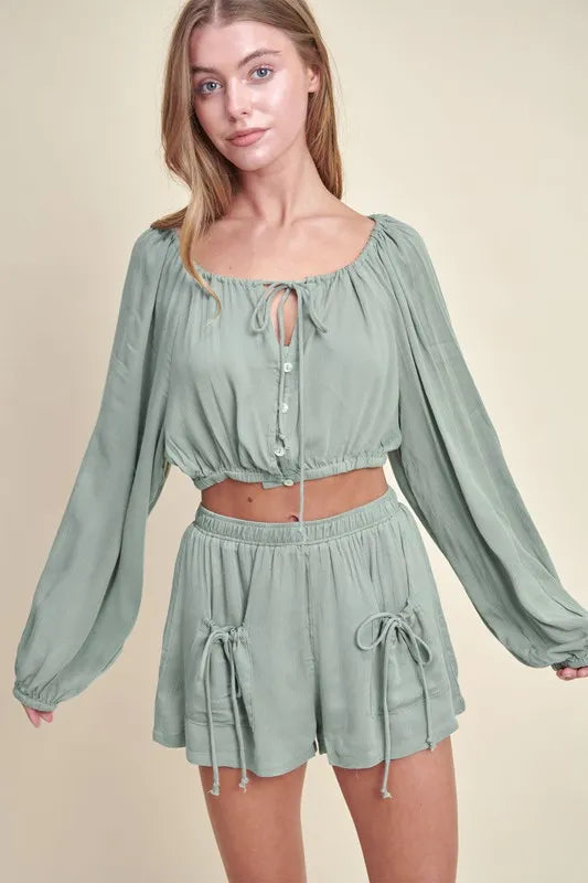 Dusty sage MABLE Gauze long sleeve button crop top and matching short set by Trendsi, shown on a model.