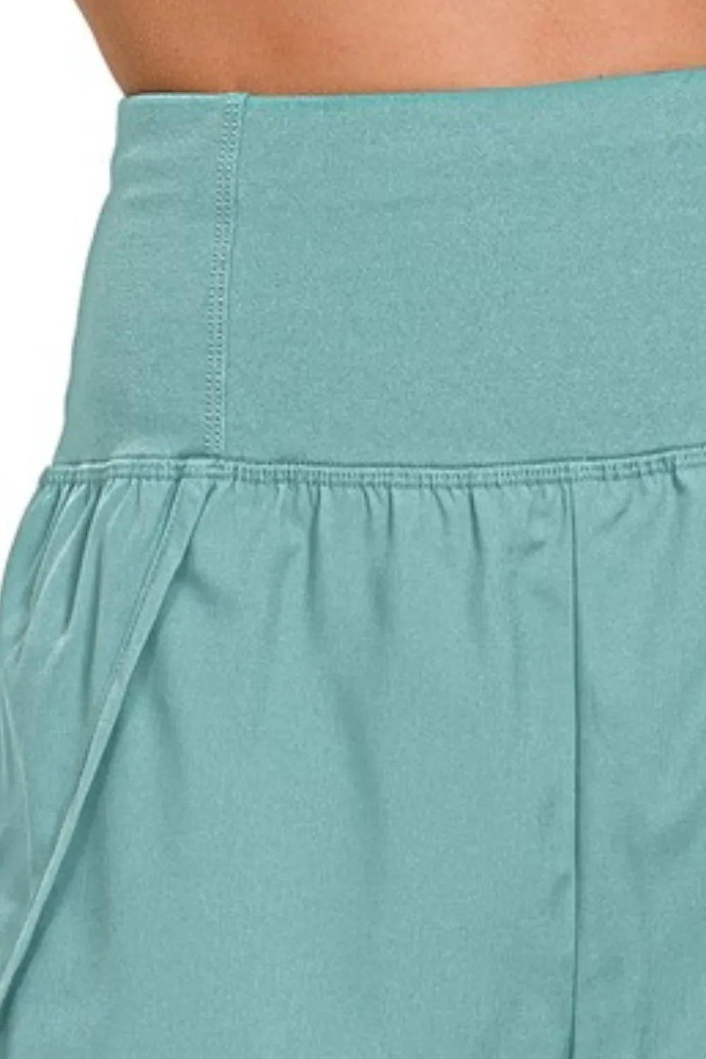 Dusty teal Zenana high-waisted running shorts with zippered back pocket, designed for comfort and active wear.