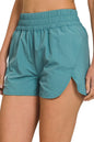 Dusty teal Zenana windbreaker running shorts with smocked waistband, designed for comfort and active wear.