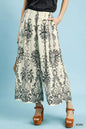 Ecru Umgee border print wide leg pants from Trendsi featuring a relaxed fit and stylish wide-leg silhouette.