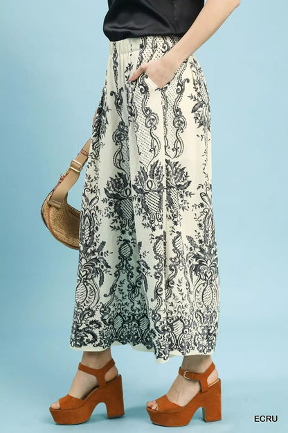 Ecru Umgee border print wide leg pants from Trendsi, featuring flowy fabric and a relaxed fit with a stylish border design.