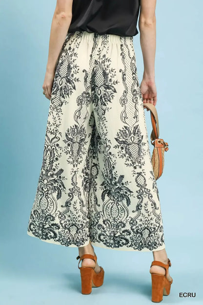 Ecru Umgee border print wide-leg pants from Trendsi featuring a relaxed fit and stylish wide-leg silhouette.