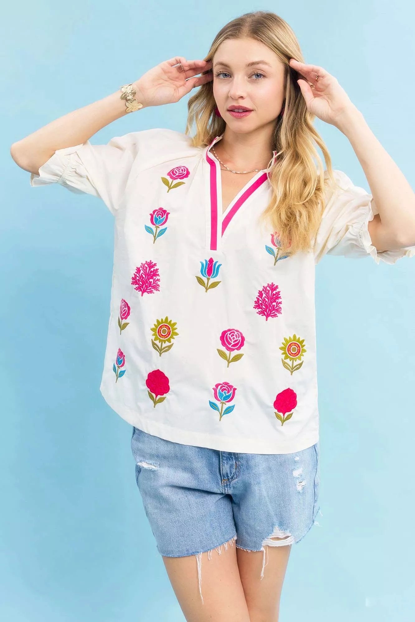 Ecru floral embroidered top by Umgee with contrast trim, featuring intricate embroidery and a relaxed fit for casual wear.
