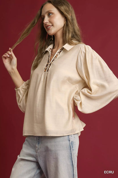Ecru long sleeve blouse by Umgee with leopard print trim, featuring a relaxed fit and stylish detailing.