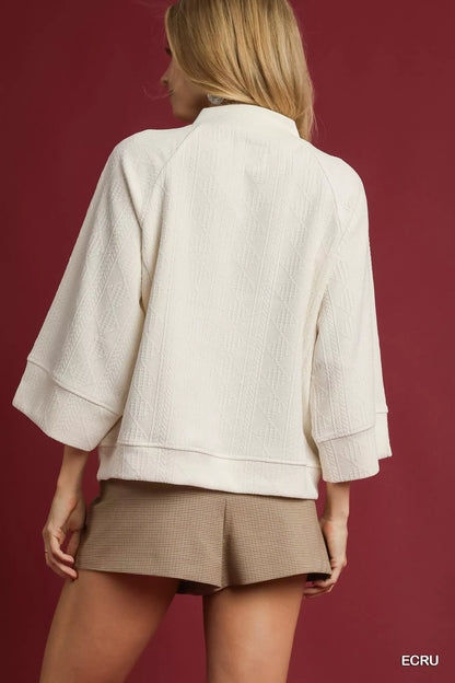 Ecru textured knit V-neck top by Umgee, casual style with a relaxed fit and soft fabric, ideal for everyday wear.