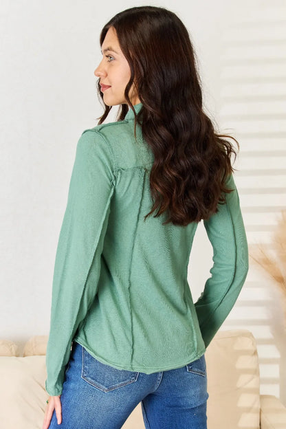Emerald green POL Exposed Seam Long Sleeve Knit Top by Trendsi, close-up of the fitted knit fabric with exposed seam details.