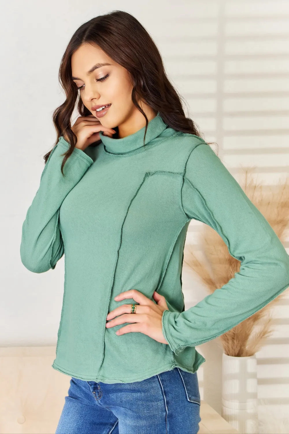 Emerald green POL exposed seam long sleeve knit top by Trendsi, showcasing a fitted design with visible seam details.