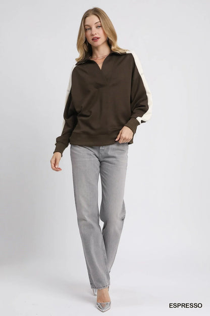 Light blue and navy color block polo sweatshirt by Umgee, featuring a casual fit and classic collar, styled on a model.