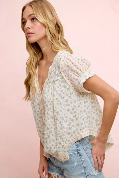 Trendsi BiBi Floral Crinkle Neckdrop short sleeve blouse top featuring a colorful floral pattern and relaxed fit.