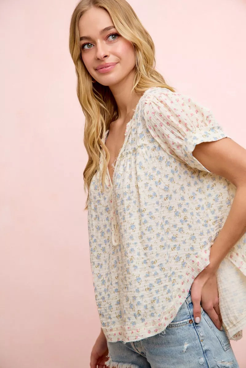 Trendi BiBi floral crinkle short sleeve blouse with a neckdrop and relaxed fit, featuring colorful floral print and lightweight fabric.